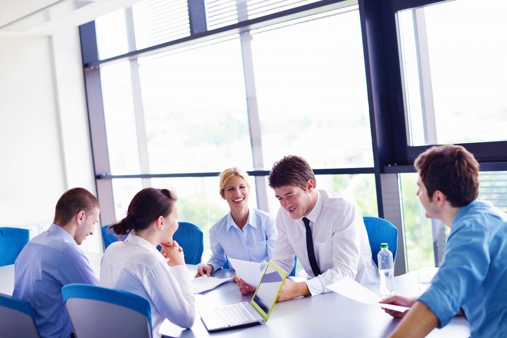 Group of happy young  business people in a meeting at office